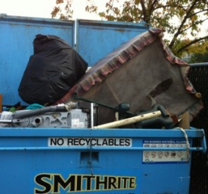 couch in garbage bin